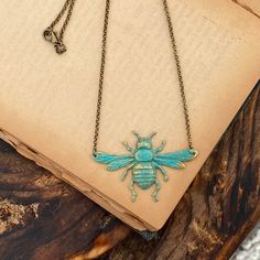 "Oxidized silver plated bee pendant made from vintage tooling. Hung from 16 inches of antiqued silver chain finished with a lobster claw clasp. The bee measures 2 1/4\" by about 1 1/4\". I also have this piece in antiqued brass and patina. I can make the length of any necklace longer or shorter by request :) Each purchase comes in a gift box." Vintage Bronze Pewter Jewelry, Vintage Pewter Necklaces With Soldered Details, Vintage Metal Necklace With Patina, Vintage Patina Metal Necklace, Vintage Soldered Pewter Necklaces, Vintage Pewter Necklaces For Gifts, Vintage Pewter Necklace With Antique Finish, Vintage Hand-cast Bronze Necklaces, Vintage Hand Cast Bronze Necklaces