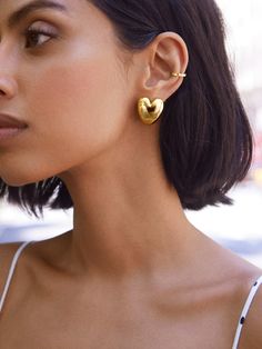 Sprinkle some love into your everyday outfits with the Laura Earrings — gold heart huggie earrings. Subtle, sweet, and oh-so-charming, these earrings pair well with almost anything for effortless styling. Gold Heart-shaped Huggie Earrings For Everyday, Everyday Gold Heart Huggie Earrings, Everyday Gold Heart-shaped Huggie Earrings, Gold Single Heart Earring For Everyday Wear, Chic Heart-shaped Everyday Earrings, Chic Everyday Heart-shaped Earrings, Everyday Gold Plated Huggie Heart Earrings, Gold Plated Heart Earrings For Everyday, Gold Plated Heart Drop Earrings For Everyday Wear