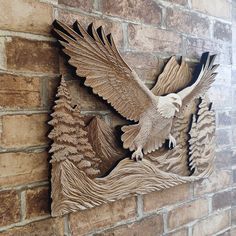 an eagle and pine tree carved into the side of a brick wall