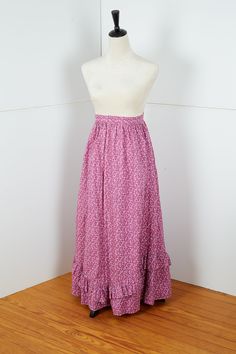 "Unique handmade full length A-line skirt with no tag, an extra ruffle layer on the bottom and a wide 48\" spread at the bottom. This skirt creates presence with some ease, texture and whimsy of a small minimal floral pattern.  Measured flat: 38\" L 12\" W waist 48\" W bottom of skirt See photos for details on condition. It has no visible signs of wear. No tears or rips. All sales final Domestic US shipping included" Ruffled Flared Skirt Dress, Long Flowy Petticoat With Attached Cancan, Flowy Full Petticoat With Ruffles, Spring Maxi Dress With Ruffled Relaxed Skirt, Fitted Pleated Tiered Maxi Skirt, Pink Tiered Ruffle Maxi Skirt, Pink Tiered Maxi Dress With Ruffles, Voluminous Ruffled Petticoat, Fitted Tiered Skirt With Ruffles