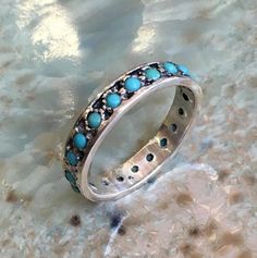 La la land~~~~~~~~~~~~~~~~This is a lovely multistone sterling silver eternity band with turquoise stones. if you wish to set different stones just let us know.(R2560)Construction & Dimensions:~~~~~~~~~~~~~~~~~~~~~~~sterling silver, turquoiseApproximate width: 4mmplease indicate your requested size in the order.About our jewelry~~~~~~~~~~~~~~ All of artisanfield jewelry collection is handmade.We  make the artisanfield designs from a goldfilled wire. *If, for any reason, you are not completel Ring Wedding Band, Infinity Ring, Turquoise Stones, Small Rings, Gold Wedding Rings, Multi Stone Ring, Eternity Band, Ring Wedding, Ring Sterling Silver