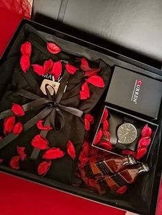 a black box with red roses and other items