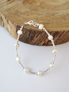 Simple white freshwater pearl bracelet made with silver spacer beads. Adjustable size, will fit most sizes. Nickel free and hypoallergenic. Silver plated. Single Pearl Necklace, Freshwater Pearl Drop Earrings, Pearl Drop Necklace, Bracelet Simple, Baroque Pearl Earrings, Freshwater Pearl Bracelet, White Freshwater Pearl, Cute Bracelets, Simple White