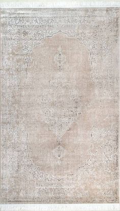 an old rug with faded edges and a circular design on the middle, in neutral tones