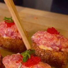 small appetizers with toothpicks in them on a table