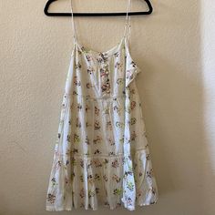 Off-White Floral Urban Outfitters Dress With Buttons, Size M, New With Tags White Cotton Sundress For Spring, Casual White Flowy Dress, White Floral Print Sundress For Vacation, White Cotton Mini Dress With Floral Print, White Cotton Mini Dress For Vacation, White Flowy Summer Sundress, White Smocked Sundress For Spring, White Floral Print Sundress For Spring, White Summer Sundress For Daywear