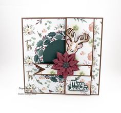 a christmas card with a deer and poinsetti