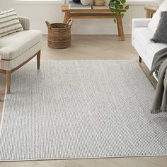 a living room with two chairs and a rug