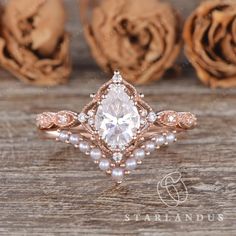 a close up of a ring on a wooden surface with flowers in the background and roses behind it