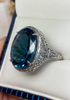 Natural London Blue Topaz Ring Description Persian Design#230 Made-Custom This is a brand new stunning Art Deco/Vintage designed sterling silver filigree 18ct oval Natural/Genuine London Blue Topaz ring. The oval full cut high-quality VS to VVS Topaz is 18mm (just shy of 3/4th of an inch) by 13mm (1/2 inch) in dimension... This ring is 21mm NS on the finger. The inside of the band is marked 925 for sterling. Notice the beautiful filigree swirl like the craftsmanship of the silver setting. This l Classic Sapphire Ring With Intricate Design, Oval Shape, Classic Oval Sapphire Ring With Intricate Design, Formal Oval Engraved Filigree Ring, Antique Oval Topaz Ring For Formal Occasions, Oval Gemstone Filigree Ring For Formal Events, Oval Sapphire Ring With Filigree For Formal Occasions, Formal Oval Sapphire Ring With Filigree, Oval Sapphire Ring With Intricate Design, Classic Oval Topaz Ring