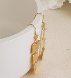 "18K Gold Plated handmade hammered rectangles bar earrings dangling from 18K Gold plated over silver ear wires. Lightweight and comfy to wear these earrings are great sparkle for everyday! * They will make a great gift! * A total length of the earrings is 33 mm/ 1.4\" approx from top to bottom. * Weight: 5.8 Grams * Material: 18k Gold Plated * The gold plating is a high quality 3 microns 18k gold thick * Pendants Highet 34mm, Width 13mm. * Ear wires are gold plated over silver * All earrings wit Minimalist Earrings Gold, Earrings Dangling, Gold Earrings For Women, Rectangle Earrings, Gold Statement Ring, Earrings Geometric, Hammered Gold, Dangly Earrings, Earrings Long