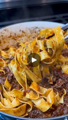 a bowl filled with pasta and beef sauce