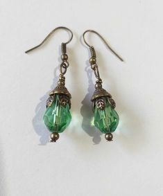 Emerald green Victorian bronze earrings Boho earrings Bronze earrings Bohemian earrings Vintage emerald green teardrop flower earrings gift boho earrings Edwardian earrings Gothic earrings Beautiful bronze Victorian style earrings with emerald green teardrop faceted glass beads. Antique style bronze tone Emerald green filigree earrings . Boho earrings. Bohemian earrings . Romantic style earrings. Baroque style earrings . Beautiful emerald-green earrings.  Perfect Gift for Her ! FREE SHIPPING  The Chain measures approximately 46 cm ( 18.20 inches). Material: bronze tone pendant, green teardrop faceted glass beads, bronze tone chain , bronze toned ornaments beads.  Length of necklace :  18.20 ( 46cm) Length of earrings with hooks - 1.7 (4.5 cm) If you have any question, please contact me ! T Green Nickel-free Teardrop Drop Earrings, Green Nickel-free Teardrop Earrings, Green Teardrop Drop Earrings Nickel Free, Green Teardrop Brass Jewelry, Handmade Green Teardrop Earrings, Green Teardrop Jewelry With Ear Wire, Green Teardrop Drop Earrings For Jewelry Making, Green Teardrop Earrings For Jewelry Making, Nickel-free Green Drop Jewelry