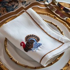 a white plate topped with a turkey napkin