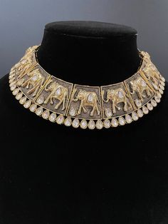 This beautiful piece is handcrafted to perfection and comes in 3 gorgeous colors. It's perfect to add a traditional touch to any event and is so unique with its intricate design. The necklace comes with a matching set of earrings. Handmade Kundan Necklace For Ceremonial Occasions, Silver Kundan Choker With Intricate Design, Chandbali Hand Set Choker For Festivals, Ceremonial Kundan Necklace With Motifs, Silver Kundan Choker Necklace With Intricate Design, Silver Kundan Choker For Ceremonial Occasion, Traditional Hand Set Kundan Necklace, Ceremonial Kundan Jewelry With Motifs, Ceremonial Kundan Handmade Temple Necklace