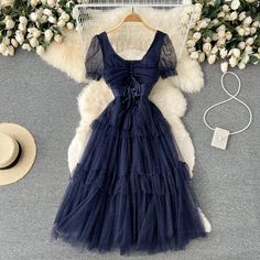 Immerse yourself in the ethereal charm of the Midnight Whisper Navy Tulle Cocktail Dress. This dress is a true embodiment of fairy-tale elegance, designed for those who appreciate the delicate interplay of shadow and light. The bodice of the dress is a masterpiece of design, featuring a corset-style lace-up back that not only provides a customizable fit but also adds a vintage touch to the modern silhouette. The soft cap sleeves and the sheer overlay on the bodice are adorned with subtle dotted Fairycore A-line Party Dress, A-line Fairycore Dress For Party, Fairycore Party Dress With Sweetheart Neckline, Summer Tulle Dress With Sweetheart Neckline, Ethereal Summer Fairy Dress, Ethereal Fairy Dress For Summer, Fitted Tulle Fairy Dress For Garden Party, Summer Tulle Mesh Dress With Sweetheart Neckline, Balletcore Style Summer Party Dresses