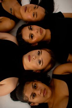 four women are laying down in a circle