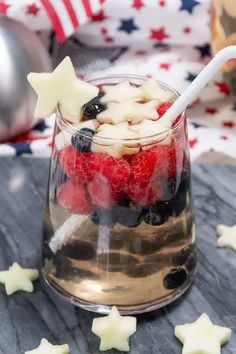 a patriotic dessert in a glass with strawberries and blueberries