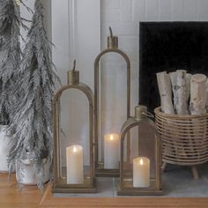 some candles are sitting in front of a fireplace