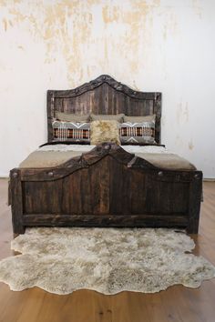 an old wooden bed with two pillows on it