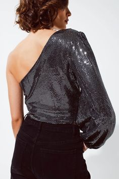 Step into the spotlight with our Party Cropped One Shoulder Top, featuring stunning glitters and a single long sleeve in classic silver. This top is perfect for parties and casual events, offering a blend of style and comfort that flatters all body types.    With its cropped length and ruched volume sleeves, this top exudes a sense of glamour and sophistication. The one-shoulder design and sequin embellishments add a dazzling touch to your outfit. It's equipped with a zip side for easy wear.    Crafted from 95% Polyester and 5% Elastane, this top provides a comfortable and flexible fit. Our model is wearing size S and stands at 5'' with measurements of 32-23-35. For your convenience, we offer S-M-L sizing, corresponding to US sizes 4, 6, and 8, respectively.    Step out in style with our P Glamorous Long Sleeve Tops With Contrast Sequin, Glamorous Fall Top With Contrast Sequin, Glamorous Fall Tops With Contrast Sequin, Glamorous Contrast Sequin Top For Fall, Chic Long Sleeve Glitter Tops, Long Sleeve Sequin Tops For Holiday Party, Long Sleeve Tops With Contrast Sequin For Night Out, Contrast Sequin Long Sleeve Tops For Night Out, Glamorous Sequin Tops For Winter