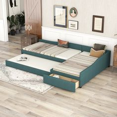 a bed that is sitting in the middle of a room with drawers on each side