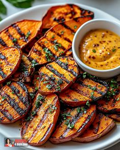 grilled sweet potato wedges on a white plate with mustard dipping in the bowl