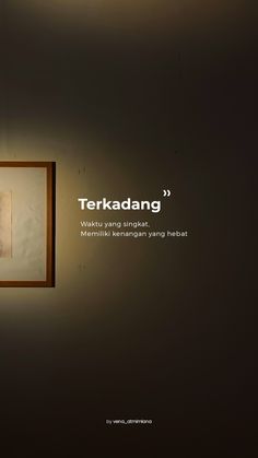 there is a photo hanging on the wall with words above it that say terkadang