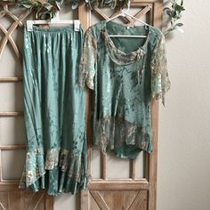 This Is Such A Beautiful Set . Some Embellishing On Top . It’s Like A Sea Foam Turquoise With Silky/Shiny Flower Design . It’s Draped In A Antiquated Lace On Skirt And Top . Has A Layered Sleeve With Light Yellow And Turquoise Colored Delicate Flowers . Looks Much More Beautiful In Person . Says A Sz 10 , But I’m A 4-6 And Wear It . Pit-Pit 18 “ Has A Bit Of Stretch Skirt 14-15” Can Stretch To 18 “ All Approx Measurement. The Skirt Is Layered At The Bottom In All The Same Materials As Top , A Must Have In Closet .A Vintage , Boho Feel . I Actually Wore Once , With A Pair Of Frye Boots . I Consider New Wot . Yellow And Turquoise, Skirt And Top, Stretch Skirt, Frye Boots, Delicate Flowers, Top And Skirt, Delicate Flower, A Sea, Turquoise Color