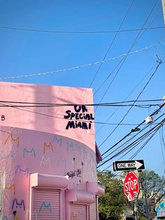 a pink building with graffiti on the side