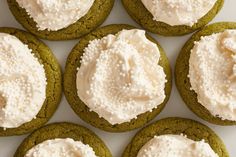 green cookies with white frosting are arranged in a circle on a plate, ready to be eaten