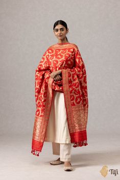 "A stunning red\u00a0handloom\u00a0masterpiece\u00a0in an exquisite Shikaargah design, featuring a\u00a0beautiful\u00a0web of zari, figures and animal motifs crafted in zari.\u00a0\n\u00a0\n\n\n\nColor\u00a0-\u00a0A ravishing\u00a0shade of\u00a0Red\n\n\n Technique\u00a0-\u00a0Classic handwoven Banarasi art passed down through generations of weaving traditions and an enduring Kadwa weave. The elaborate and laborious Kadwa (Kadhua) technique involves hand-weaving each motif separately. It takes longer on the handloom, but makes a more robust pattern which stands out on the fabric.\u00a0\n\n\n Fabric\u00a0- Soft as butter, pure Katan silk\n\n Speciality\u00a0- A luxurious drape, an opulent zari jaal, and incredibly detailed animal motifs in the finest Kadhua weave.\u00a0\n\n Tilfi Promise\u00 Jungle Scene, Animal Motifs, Katan Silk, Hand Weaving, Silk, Pure Products, Red, Pattern, Fabric