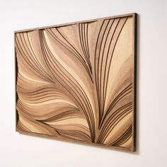 a wooden wall hanging on the side of a white wall