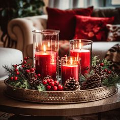 a coffee table styled for Christmas - with antique gold tray holding chunky red candles in glass cylindrical holders, with rustic centerpiece from pine cones and winter foliage. - red velvet decorative cushions add the right accent. Ideas Decoracion Navidad, Christmas Coffee Table Decor, Red Christmas Decor, Christmas Candle Decorations, Christmas Decor Inspiration, Christmas Centerpieces Diy, Christmas Themes Decorations, Christmas Table Settings