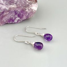 Handmade Amethyst sterling silver boho earrings for women. Purple Amethyst gemstones hang from hand crafted sterling silver, Rose Gold Fill or 14k Gold Fill ear wires or leverbacks. Dainty lightweight earrings perfect for everyday wear.  Handmade Jewelry crafted with love one at a time in my northern Michigan studio. Gemstones are nature's creations and may vary slightly in color and inclusions, but all are lovely and hand selected to match. These earrings are Dainty approx 3/4" (18mm) long including the ear wires / leverbacks. The gemstones are approx. 1/4" wide Amethyst is February's birthstone. We have more Handmade Amethyst jewelry, hair accessories, and hair jewelry available in our store: https://www.etsy.com/shop/BlueHeronJewelry?ref=seller-platform-mcnav&search_query=Amethyst I lov Teardrop Birthstone Jewelry, Teardrop Gemstone Earrings As Gift For Her, Sterling Silver Teardrop Earrings For Her, Sterling Silver Teardrop Earrings As A Gift For Her, Sterling Silver Dangle Jewelry With Birthstone, Everyday Sterling Silver Drop Jewelry, Minimalist Purple Jewelry For Everyday, Teardrop Gemstones In Fine Jewelry Style, Sterling Silver Birthstone Dangle Jewelry