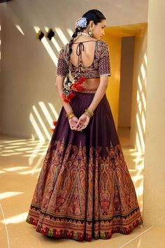 Wine lehenga with embroidered pattern, side zipper and gathered detailing. Paired with U-back blouse with tassel tie-up. Comes with a orange dupatta.
Component: 3
Pattern: Embroidered
Neckline: V-neck
Sleeve Type: Half sleeves
Fabric: Blouse and lehenga skirt: Natural silk, Dupatta: Organza
Color: Purple
Other Details: 
Gathered detailing
Tassel tie-up back
Note: The necklaces worn by the model and the outfit worn by the other male model are not for sale.
Occasion: Wedding - Aza Fashions Wine Lehenga, Orange Dupatta, Lehenga Skirt, Purple Blouse, Embroidered Neckline, Silk Dupatta, Natural Silk, Bridal Set, Bridal Lehenga