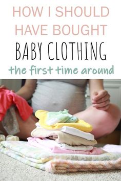 a baby sitting on the floor next to some folded clothes with text overlay that reads how should i have bought baby clothing the first time around?