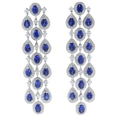 Three chandelier drops of 15.27 carats oval and pear cut blue sapphires adorn this pair of dancing earrings. Each of the deep ocean blue sapphires are haloed and linked by 4.36 carts of VS quality colorless diamonds. The delicate rainfall style of this pair of earrings set in 18K white gold is one to last an eternity. Earring Length: 3.00 inches Earring Width: 1.00 inch Sapphire Earrings Drop, The Deep Ocean, Blue Jewellery, Dance Earrings, Pearl Chandelier Earrings, Blue Sapphire Jewelry, Gold Chandelier Earrings, Antique Jewelry Indian, Deep Ocean