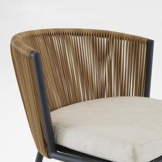 a close up of a chair with a cushion on the back and seat padding