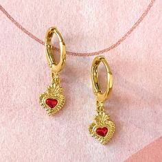 Closeup of the mini sacred heart earring on a model's ear. Sacred Heart Necklace, The Sacred Heart, Divine Love, Necklace Heart, Huggie Earrings, Wave Pattern, Sacred Heart, Gold Hoops, Dainty Jewelry