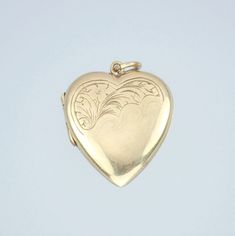 A lovely vintage Mid Century 9k gold floral engraved keepsake/picture locket pendant charm, dating to 1958. This lovely vintage estate solid 9k yellow gold locket pendant is in the form of a romantic heart with beautiful floral engravings on the front, the inside reveals two compartments for pictures, keepsakes or mementos, the pendant with an attached bail. The locket has English hallmarks with '9 .375', the Birmingham anchor, date letter 'j' for 1958 and maker's mark 'C.D', the bail is also marked '9 .375'. The pendant tests for 9k gold. The locket measures about 25mm x 18mm including the bail. The bail will hold a chain up to about 3.5mm. The total weight of the locket is approximately 3.1 grams. The locket is in excellent condition with light general wear. Both of the acrylic picture c Pendant Locket, Picture Locket, Romantic Heart, Love Photo, Photo Pendant, Gold Locket, Letter J, Maker's Mark, Heart Love