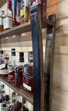 a wooden shelf filled with lots of bottles