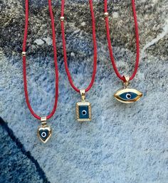 Hello, Welcome to my store ✨ If you have any questions, please contact me, i will be very happy to help you. You may want to take a look this important informations below ! ✨ 3 different shape of Blue Evil Eye 🧿Amulets with red string chain are for sale.  ✨ Pendants contain red string chain, it is 50cm (19,68inches) + 3cm adjustable chain. ✨ Gold plated, Suitable for double-sided use. ✨Mimimal collection materials are 925K good quality silver & natural gemstones & Glass Beads and very good quality rope.    ✨If you cannot find the size you are looking for, you can write to me even for your special orders; but please keep in mind; this may exceed the normal delivery time. ✨Parcels are delivered within max 2-7 days. If you need faster (1-4 days), please upgrade your shipping. Please keep in Red Pendant Charm Necklace, Red Symbolic Engraved Jewelry, Red Charms Round Pendant Necklace, Red Charms Necklace With Round Pendant, Red Pendant Charm Necklace As Gift, Red Necklace With Charms And Round Pendant, Red Pendant Charm Necklace For Gift, Red Pendant Jewelry With Charms, Red Locket Necklace For Jewelry Making