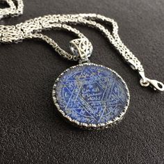 PENDANT STONE: Lapis Lazuli (natural) METAL : .925 Sterling Silver DIMENSIONS : 30 x 30 mm CHAIN: Byzantine King chain METAL : .925 Sterling Silver LENGHT: 55 cm - 21.65 inches THICKNESS: 3 mm - 0.1 inches Spiritual Sterling Silver Etched Necklaces, Spiritual Etched Sterling Silver Necklaces, Spiritual Etched Sterling Silver Necklace, Engraved Sterling Silver Star Of David Necklace, Sterling Silver Etched Amulet Necklace, Symbolic Star Of David Engraved Necklace, Sterling Silver Necklace With Carved Round Pendant, Artisan Round Engraved Necklaces, Artisan Engraved Necklaces