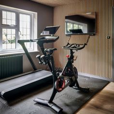 there is a bike and exercise equipment in the room