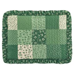 a green and white patchwork quilted placemat