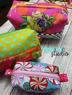 three colorful bags sitting on top of a wooden table