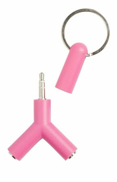 a pink keychain is attached to a metal object with a ring around it