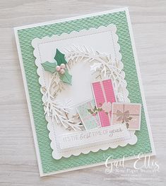 a close up of a card on a table with a paper wreath in the middle