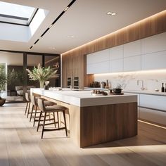 a large kitchen with an island counter and bar stools next to it in front of a window